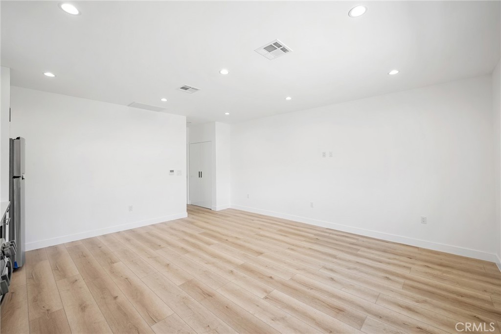 7704 Kyle Street Tujunga, CA 91042 - Photo 4 of 12 a view of empty room with wooden floor