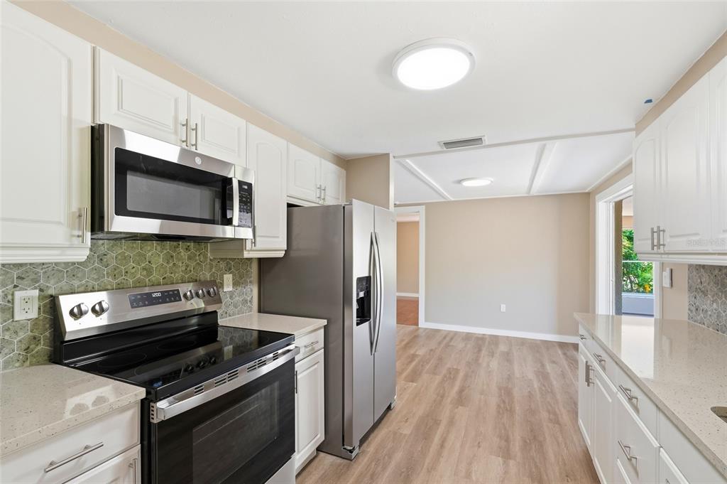 5984 Diana Road Venice, FL 34293 - Photo 15 of 36 a kitchen with a stove microwave and refrigerator