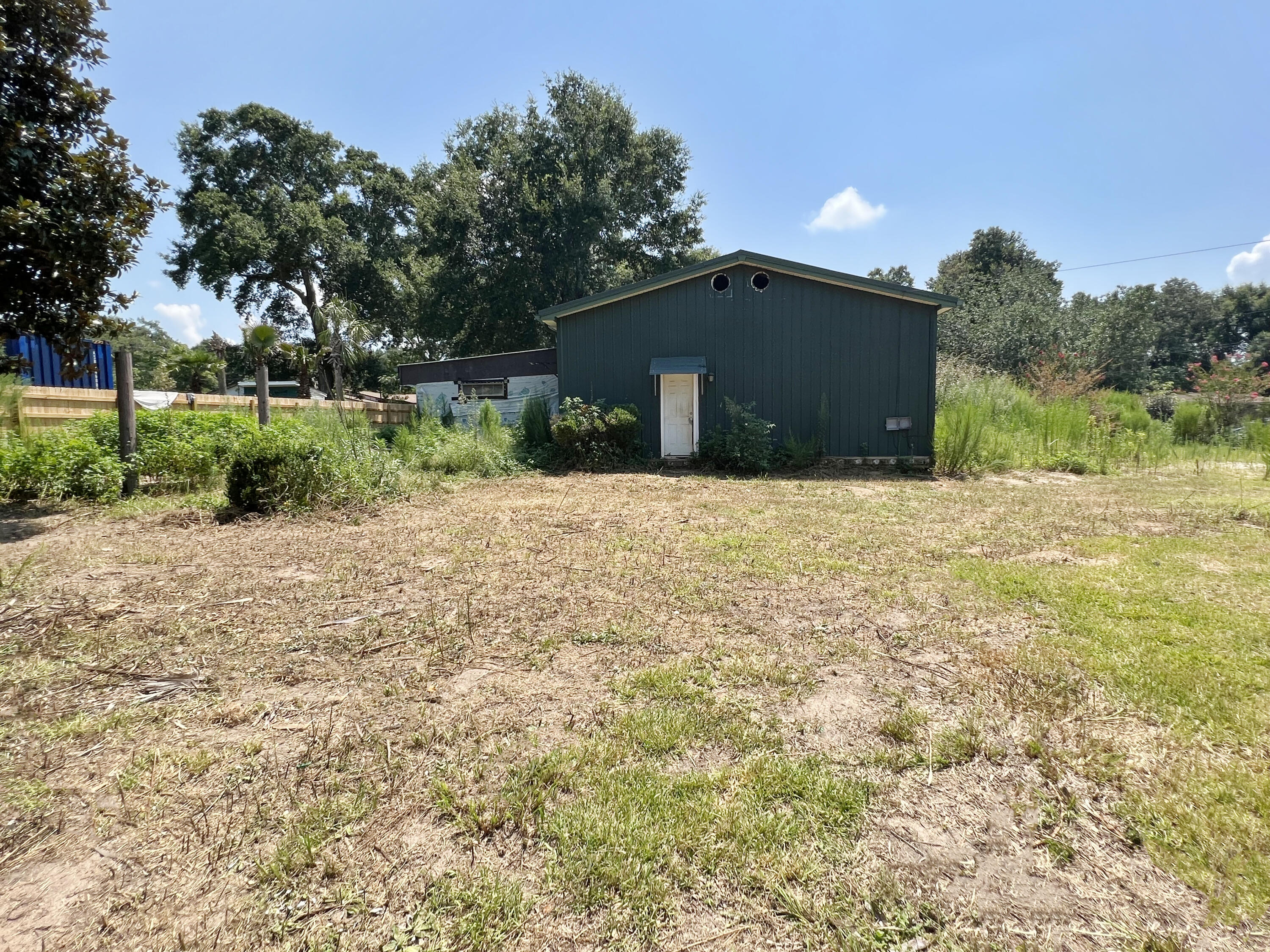 4104 Cooley Drive Pace, FL 32571 - Photo 16 of 21 a front view of a house with a yard and garage