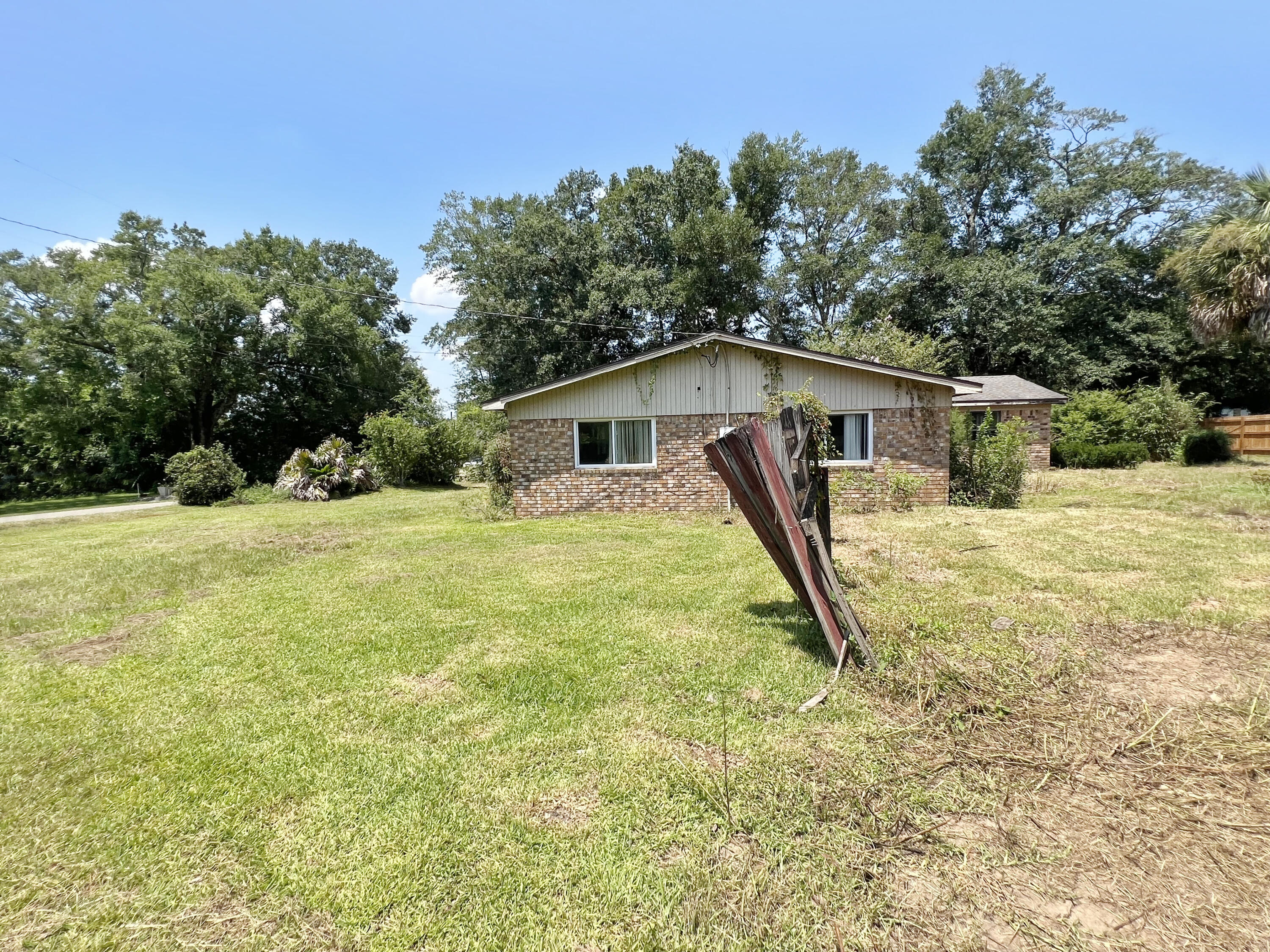 4104 Cooley Drive Pace, FL 32571 - Photo 18 of 21 a view of a house with backyard and trees