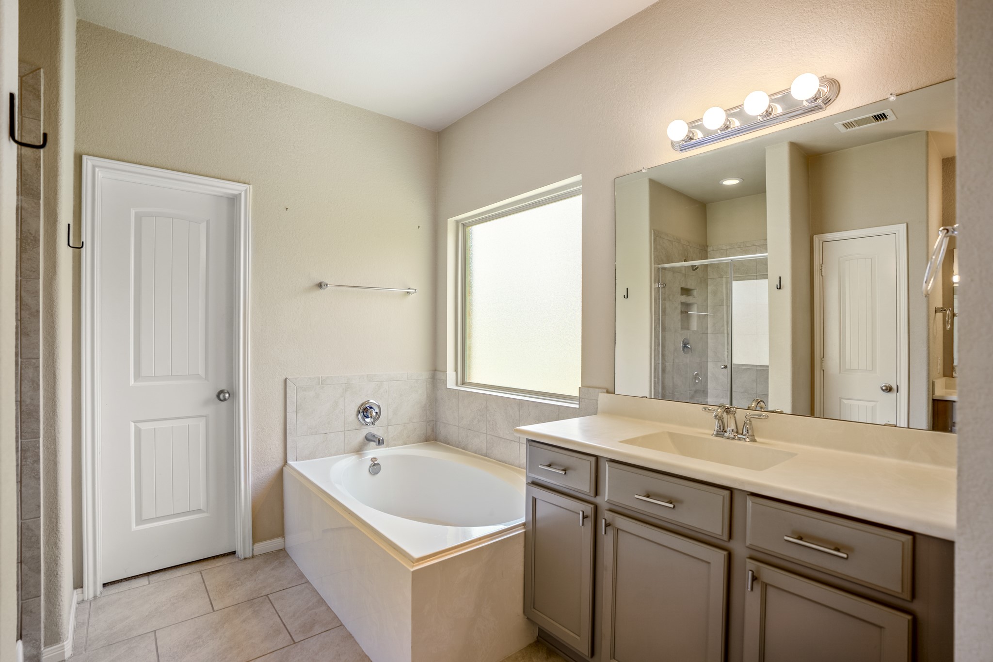 5319 Claymore Meadow Lane Spring, TX 77389 - Photo 23 of 34 a bathroom with a tub a sink double vanity and a mirror