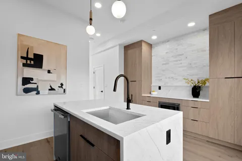 a kitchen with a sink and a refrigerator