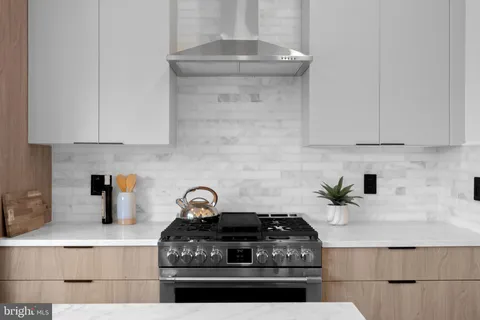 a stove top oven sitting inside of a kitchen
