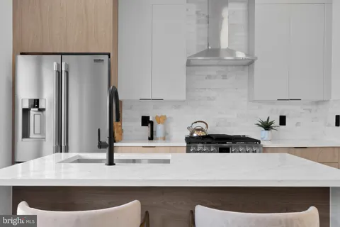 a bathroom with a granite countertop toilet a sink and mirror