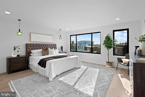 a bedroom with a large bed and a large window