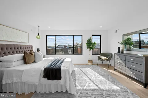 a bedroom with a large bed and a large window