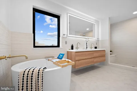 a bathroom with a granite countertop sink a mirror and shower