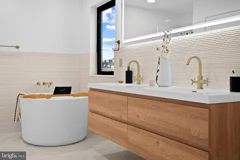 a bathroom with a sink vanity and mirror