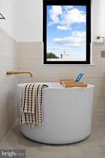 a bedroom with a bed and glass window