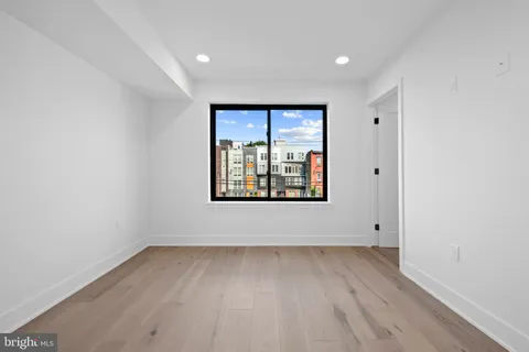 a living room with furniture a dining table and paintings on the wall