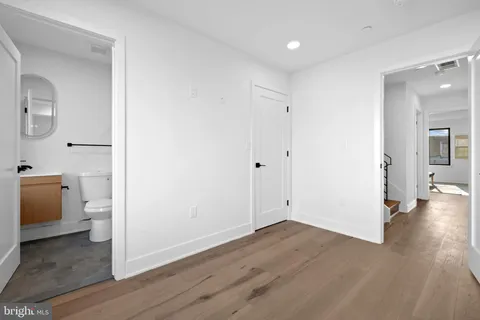a living room with furniture and a view of kitchen