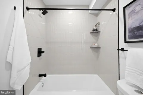 a bathroom with a toilet a sink a vanity and mirror