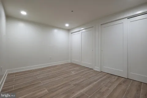 a view of a hallway with wooden cabinets