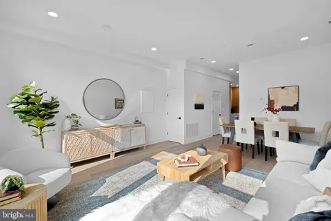 a living room with furniture flowerpot and a chandelier