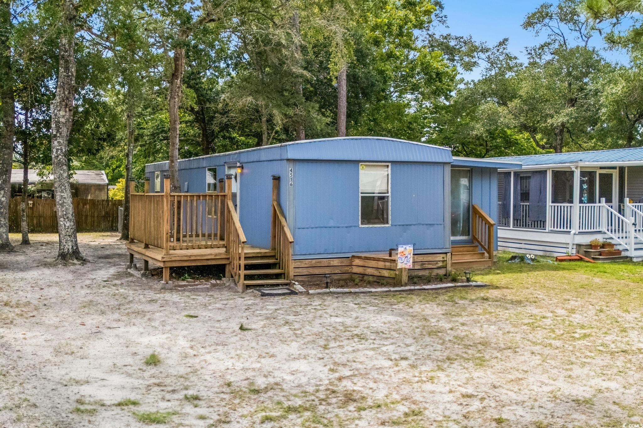 4516 Willet Street North Myrtle Beach, SC 29582 - Photo 1 of 40 View of front of property with view of wooded area and a wooden deck