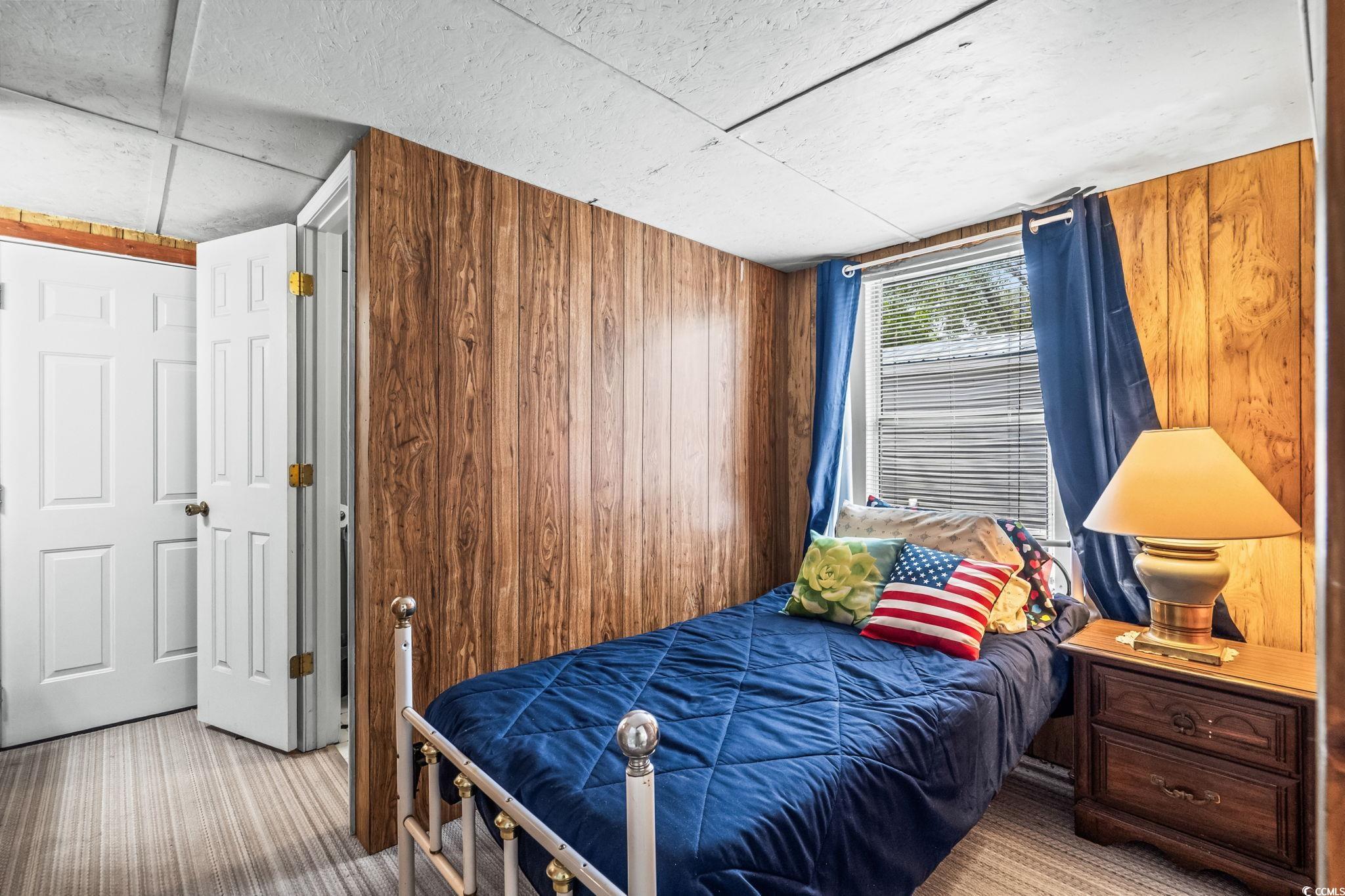 4516 Willet Street North Myrtle Beach, SC 29582 - Photo 24 of 40 Carpeted bedroom featuring wooden walls