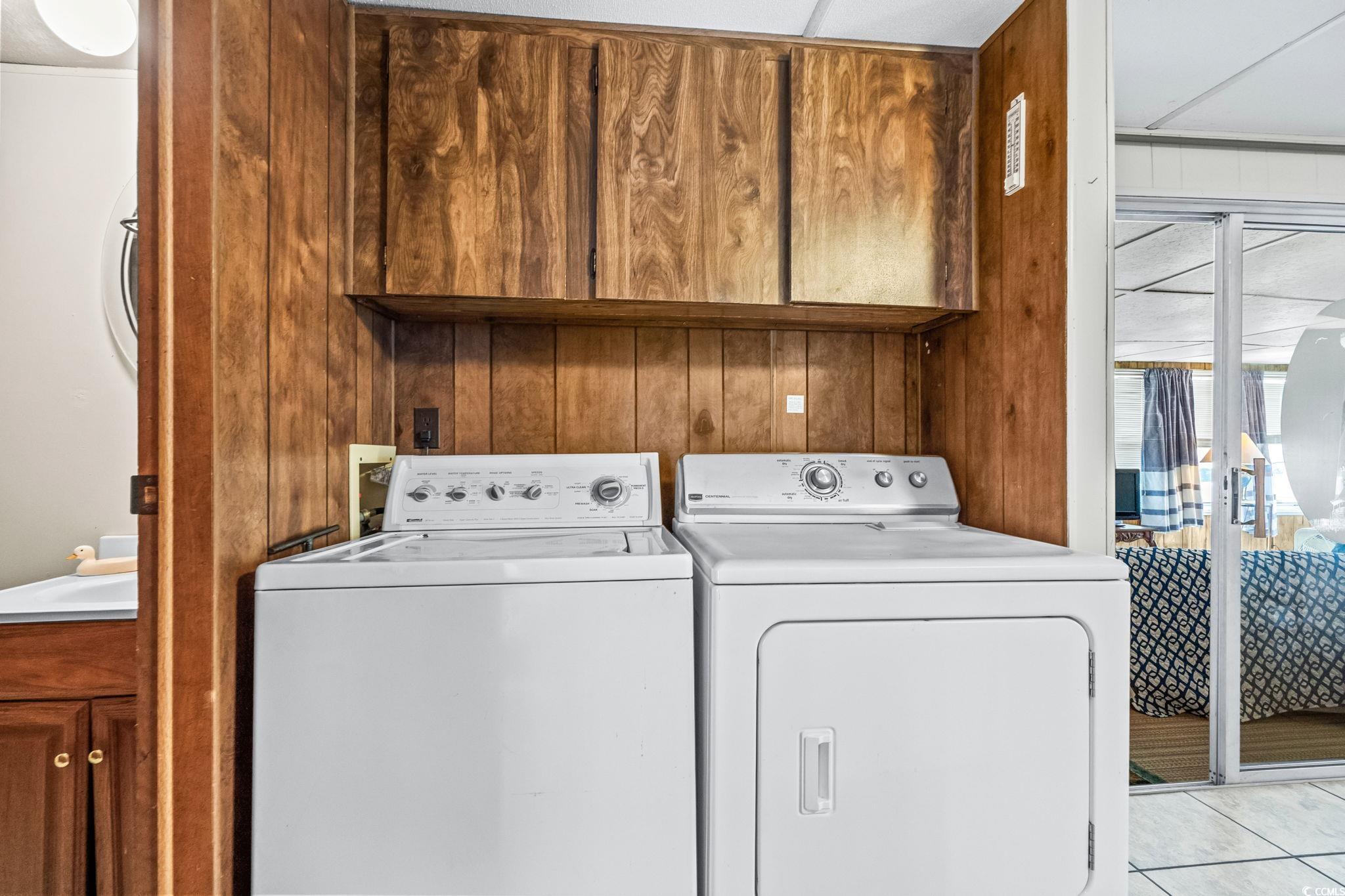 4516 Willet Street North Myrtle Beach, SC 29582 - Photo 31 of 40 Laundry area with wooden walls, separate washer and dryer, and light tile patterned floors