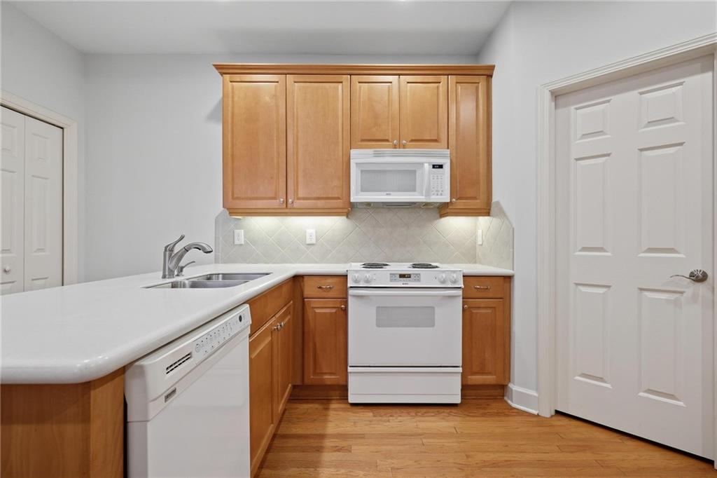 2017 MacLand Square Drive, Unit 9 Marietta, GA 30064 - Photo 14 of 30 a kitchen with stainless steel appliances granite countertop a sink stove and cabinets