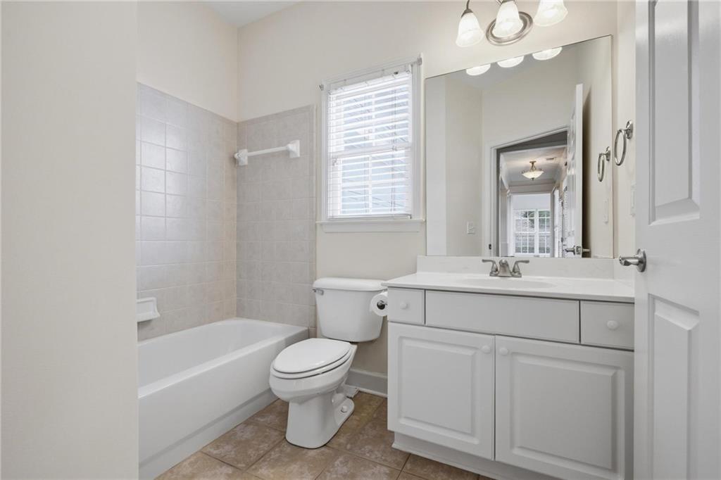 2017 MacLand Square Drive, Unit 9 Marietta, GA 30064 - Photo 23 of 30 a bathroom with a toilet a sink a mirror a bathtub and vanity