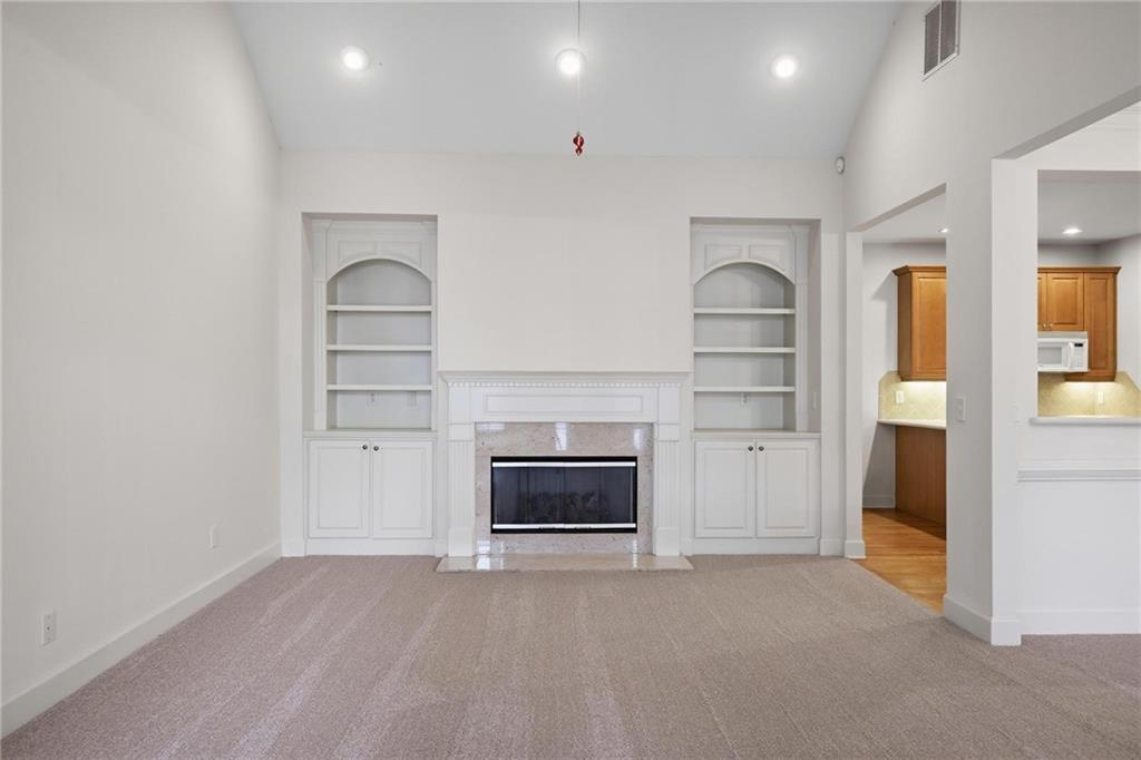 2017 MacLand Square Drive, Unit 9 Marietta, GA 30064 - Photo 4 of 30 an empty room with a fireplace and cabinet