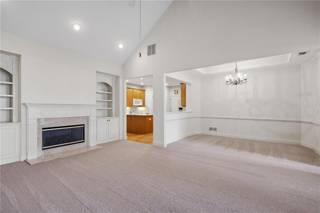 2017 MacLand Square Drive, Unit 9 Marietta, GA 30064 - Photo 5 of 30 an empty room with windows and fireplace