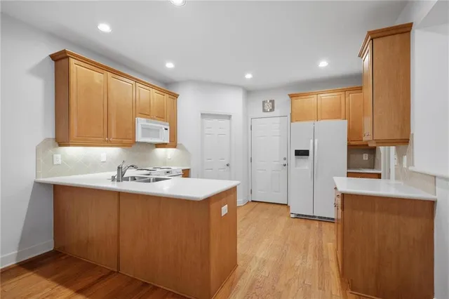 a kitchen with stainless steel appliances a refrigerator and a stove