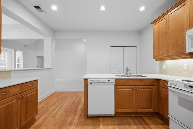a kitchen with a sink cabinets and wooden floor
