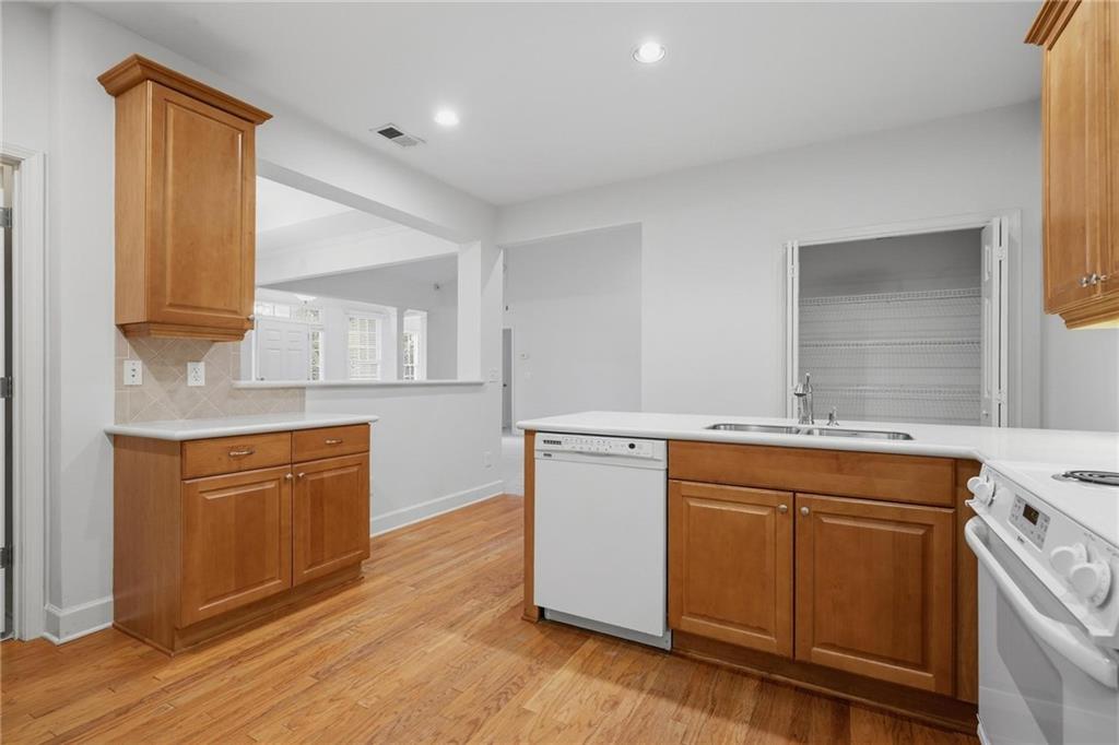 2017 MacLand Square Drive, Unit 9 Marietta, GA 30064 - Photo 10 of 30 a kitchen with stainless steel appliances granite countertop a sink a stove a refrigerator and island with wooden floors