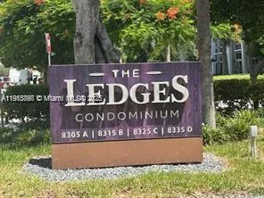 a sign that is sitting on a wooden wall