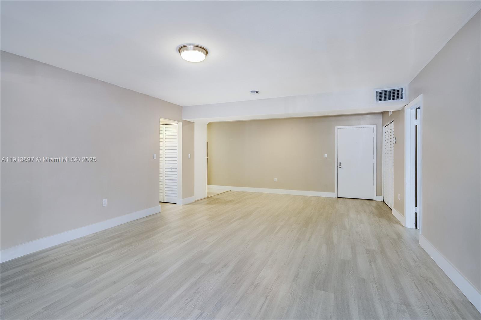 8305 Southwest 72nd Avenue, Unit 105A Miami, FL 33143 - Photo 2 of 25 a view of an empty room with wooden floor