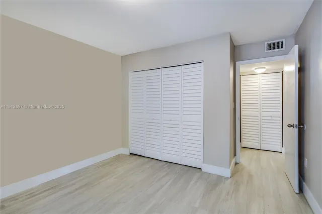 an empty room with wooden floor