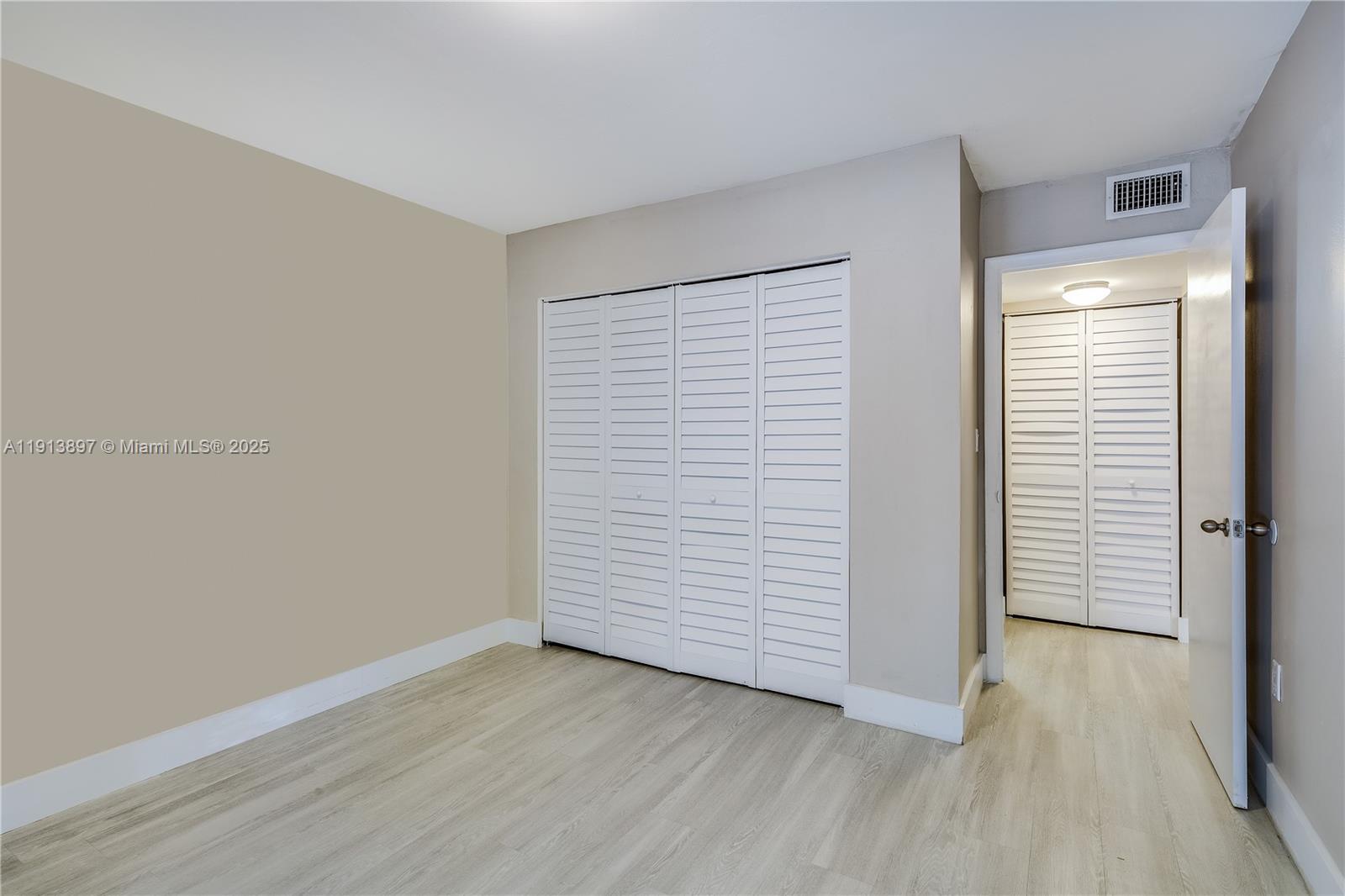 8305 Southwest 72nd Avenue, Unit 105A Miami, FL 33143 - Photo 7 of 25 an empty room with wooden floor