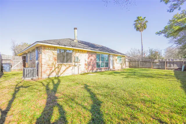 a bathroom with a bathtub and potted plants