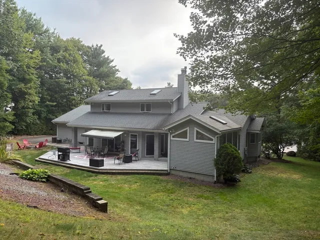 an aerial view of a house with a garden and swimming pool