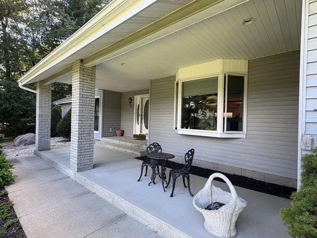 a view of a patio with table and chairs