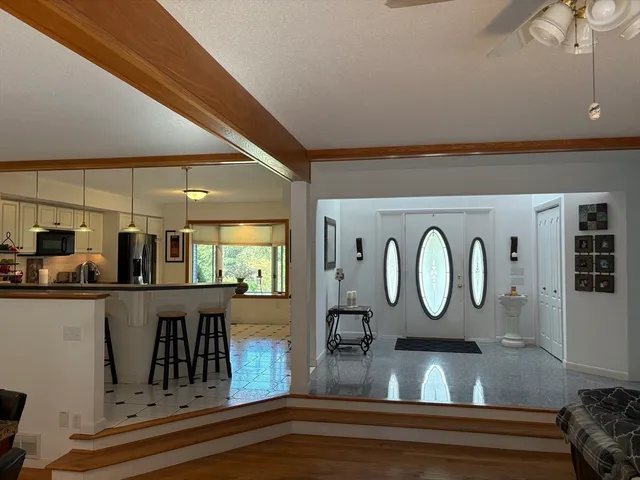 a bathroom with a tub a sink and a window