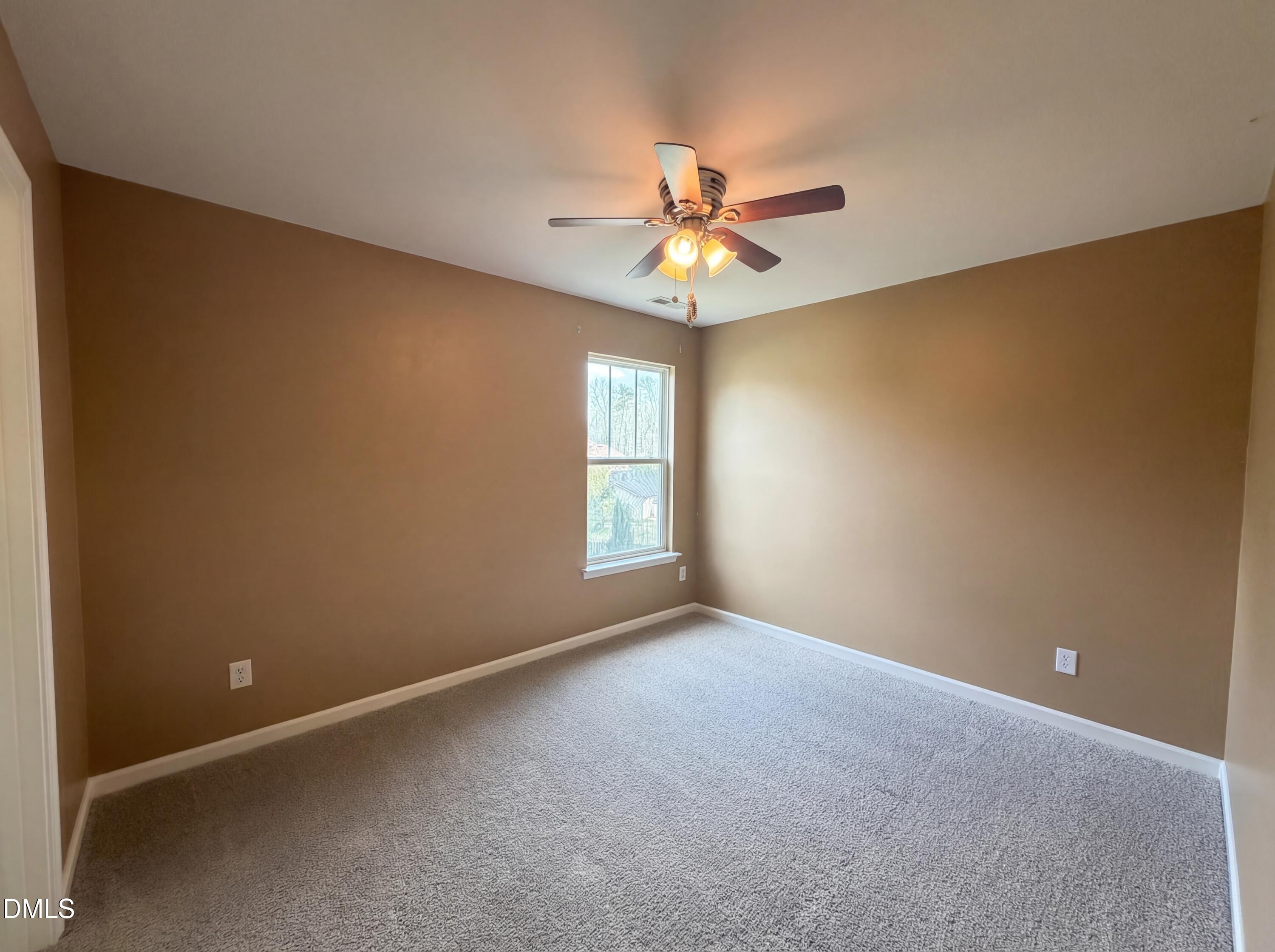 3712 Mayfair Mill Drive Raleigh, NC 27616 - Photo 13 of 16 an empty room with a window and a fan