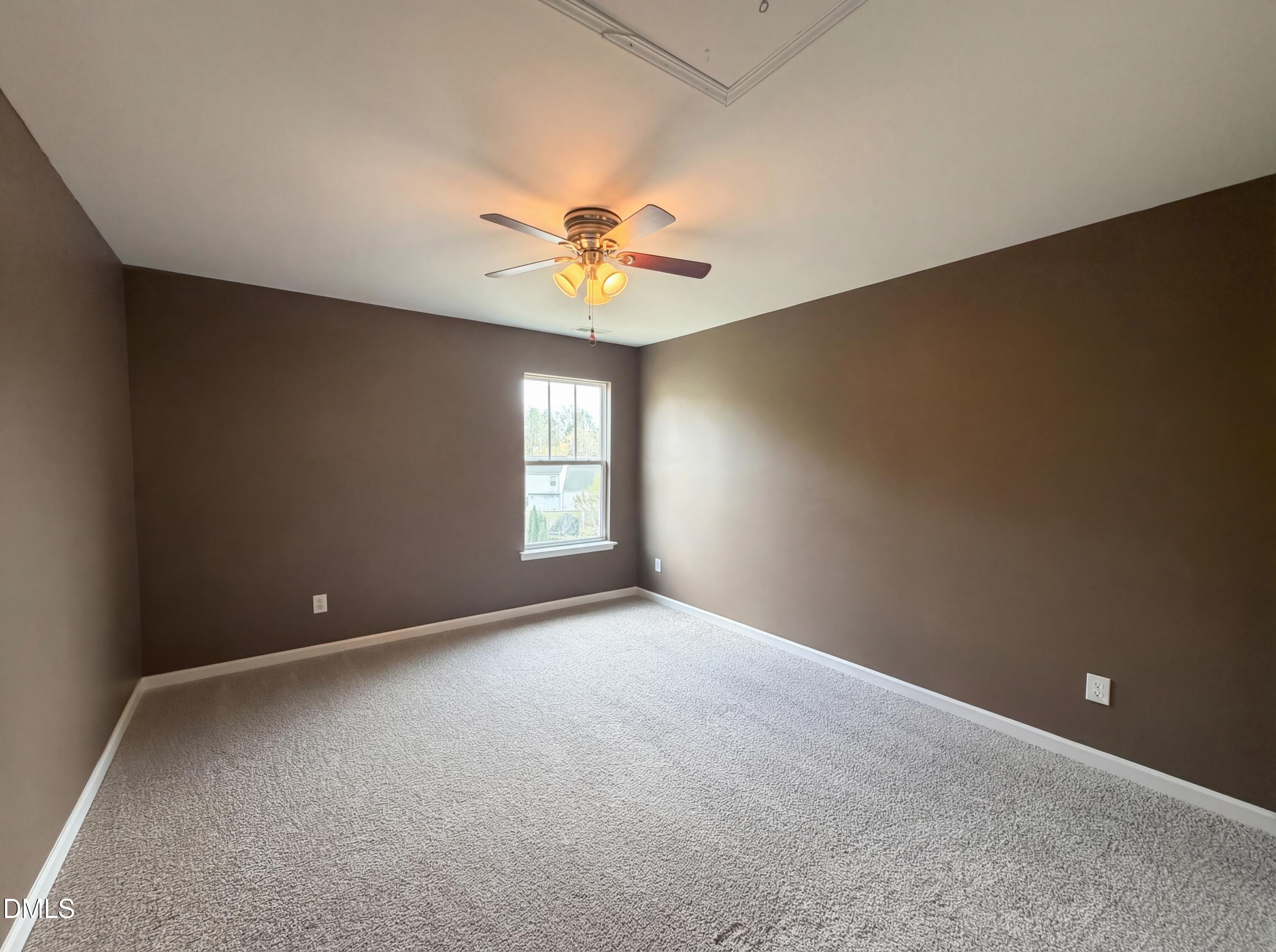 3712 Mayfair Mill Drive Raleigh, NC 27616 - Photo 14 of 16 an empty room with windows and chandelier fan