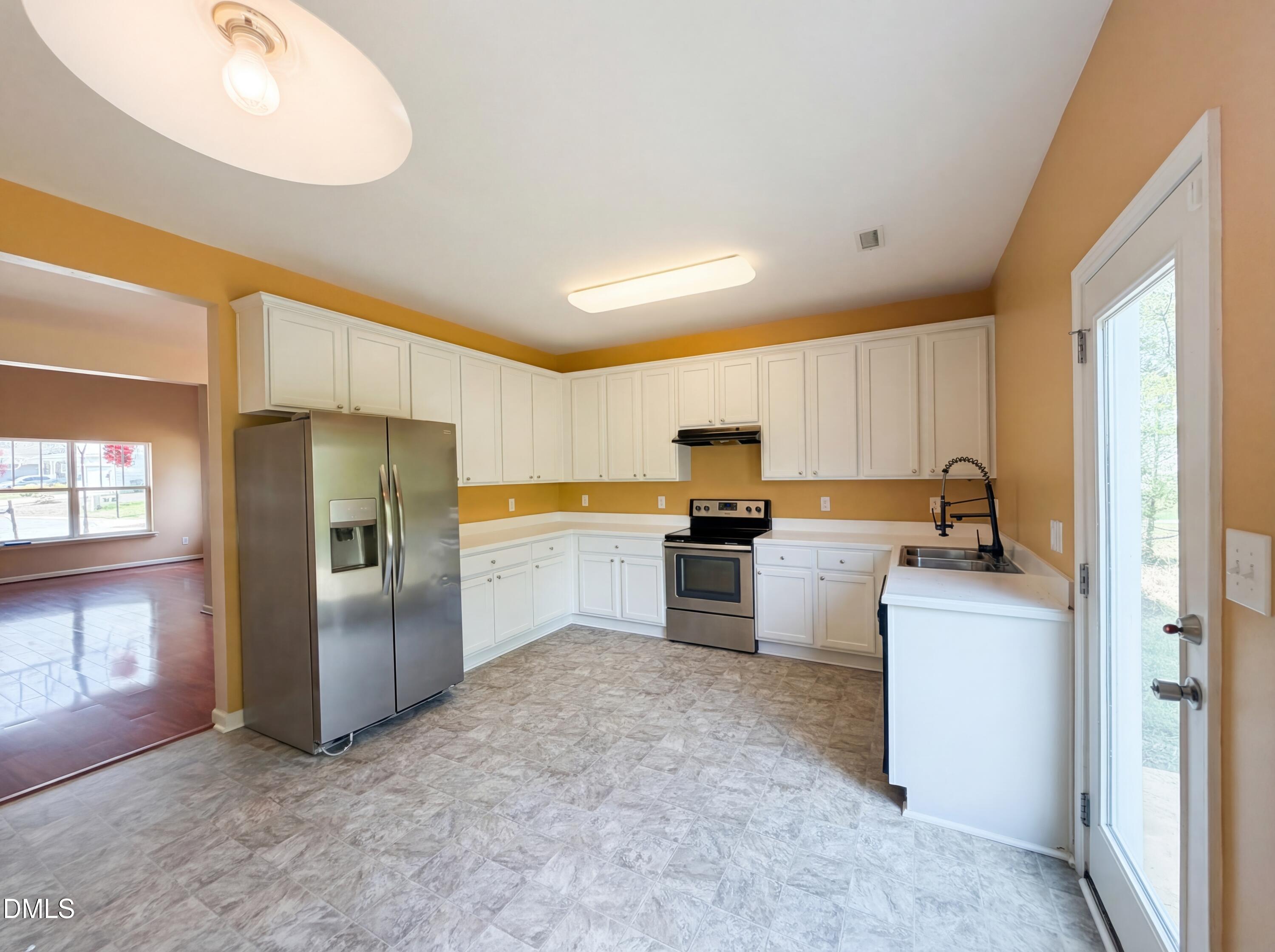 3712 Mayfair Mill Drive Raleigh, NC 27616 - Photo 2 of 16 a kitchen with refrigerator and microwave