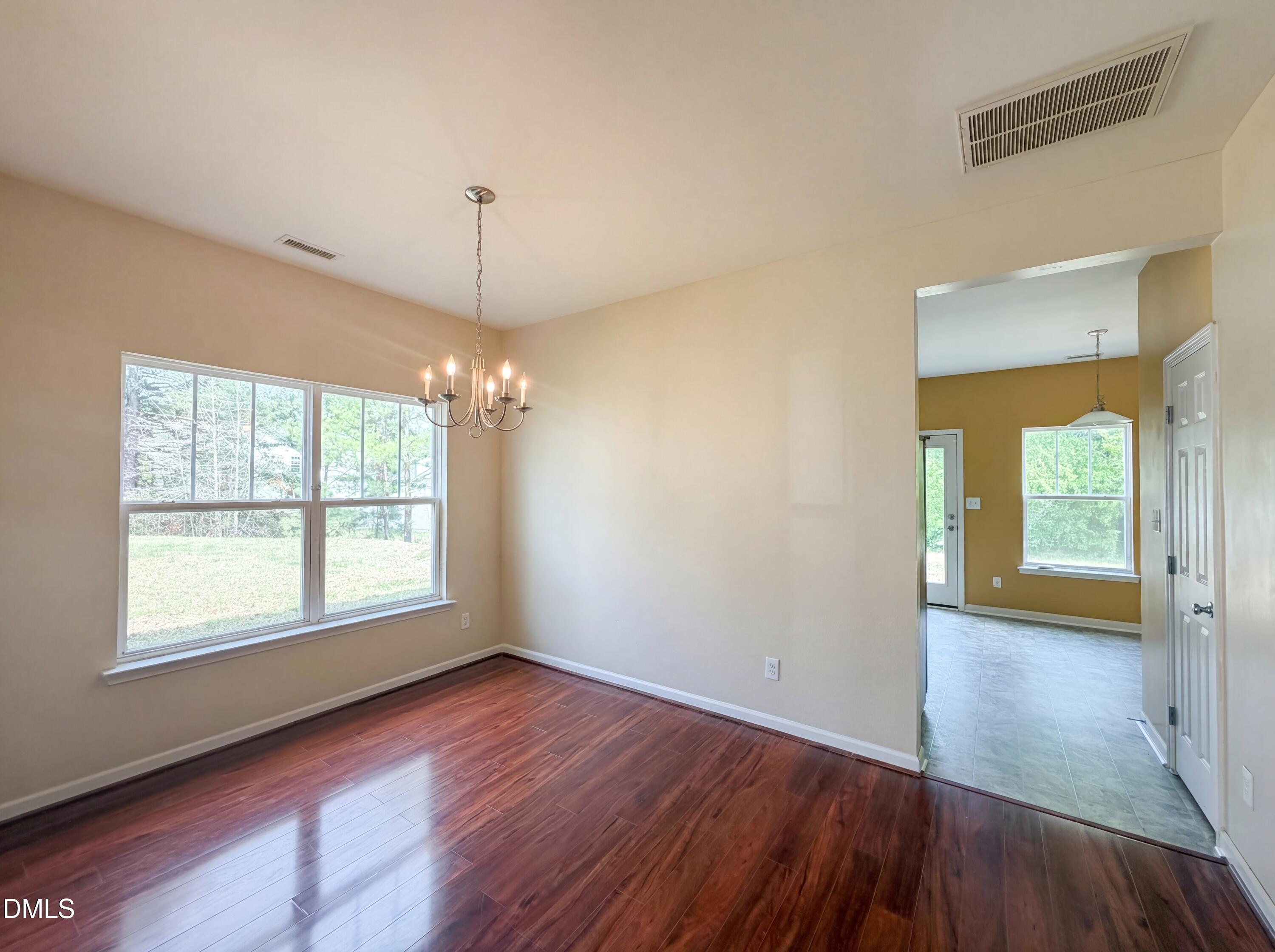 3712 Mayfair Mill Drive Raleigh, NC 27616 - Photo 8 of 16 a view of an empty room with window and wooden floor