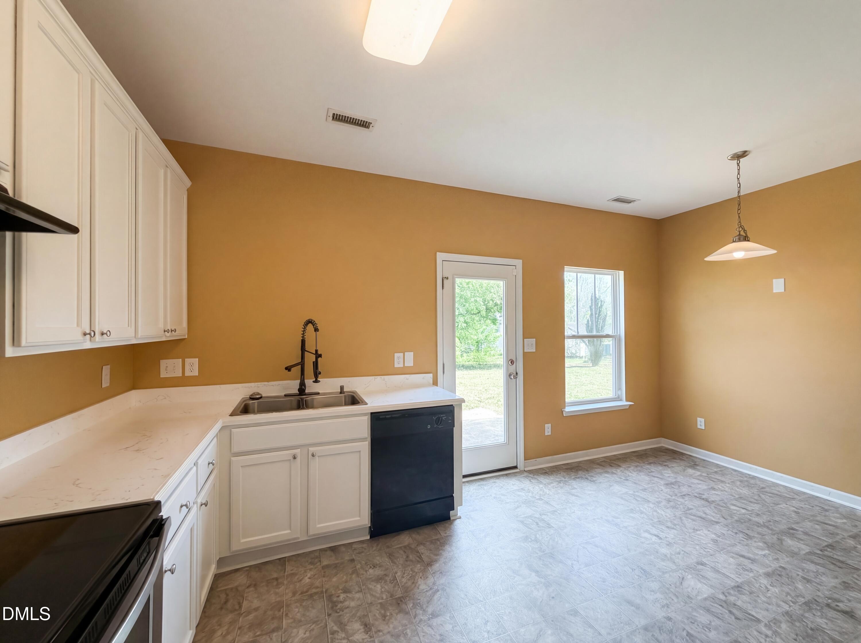 3712 Mayfair Mill Drive Raleigh, NC 27616 - Photo 9 of 16 a kitchen with a sink cabinets and window