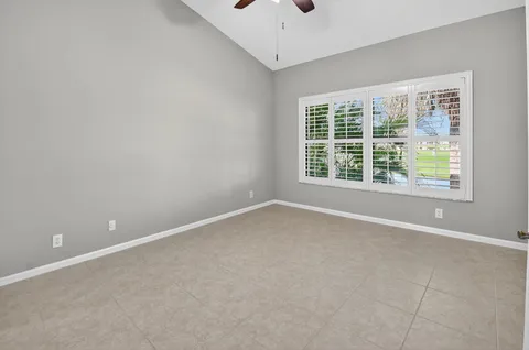 a spacious bathroom with a granite countertop sink mirror and a toilet