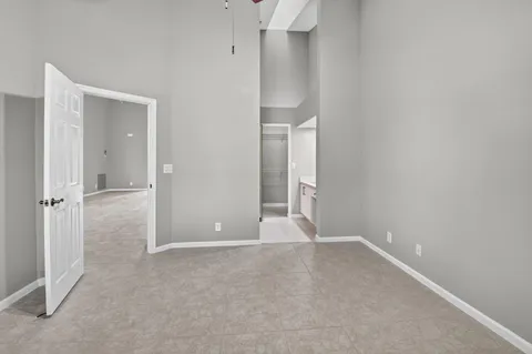 a spacious bathroom with a double vanity sink a mirror and a