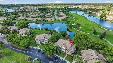 a large hall with lots of chairs a large window and a clock