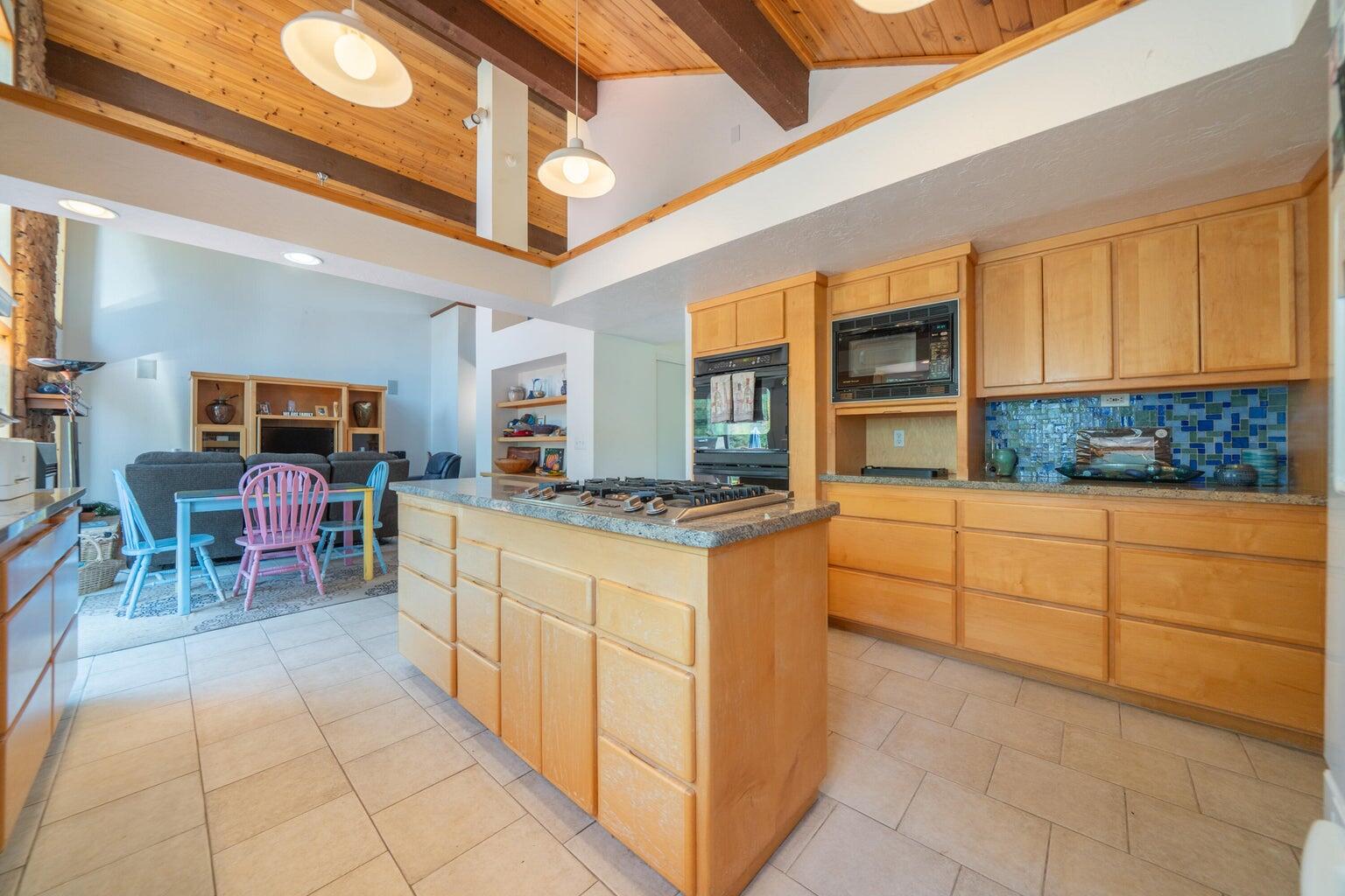 8846 Goldstone Lane Redding, CA 96001 - Photo 20 of 64 a kitchen with stainless steel appliances granite countertop a stove and cabinets