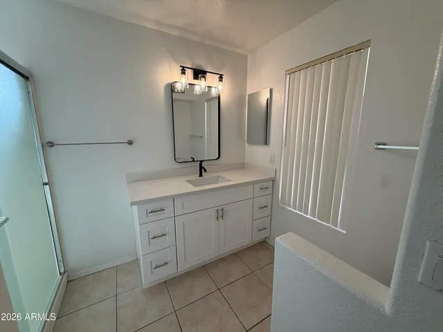 a bathroom with a double vanity sink and mirror