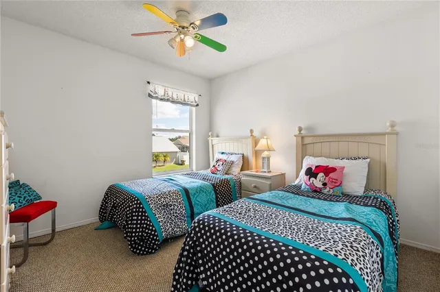 a bedroom with two beds and a chandelier
