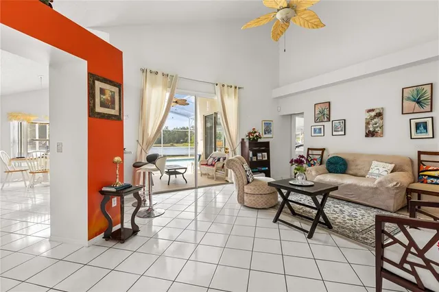 a living room with furniture a flat screen tv and a window