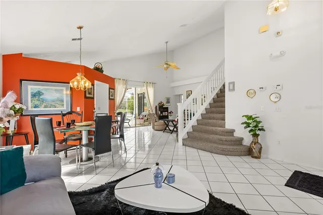 a living room with furniture a chandelier and a table