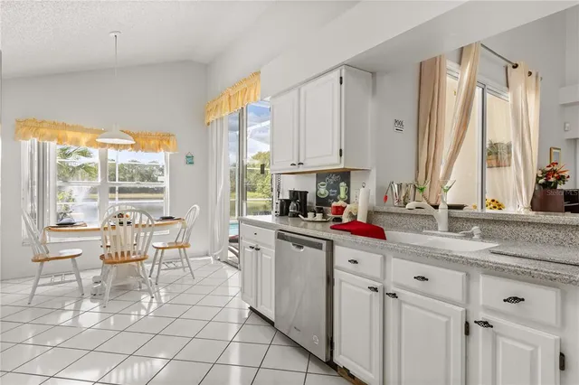 a kitchen with stainless steel appliances granite countertop a sink and cabinets